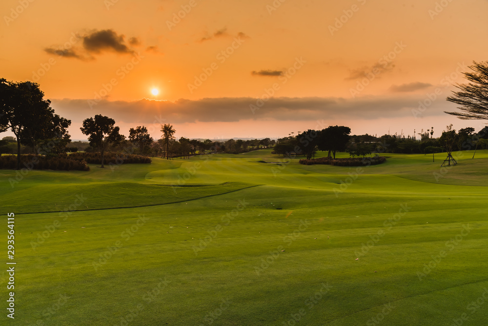 A view landscape green grass at golf course , big trees with sunlight sky background.