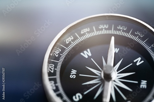 Metal antique compass on grey background