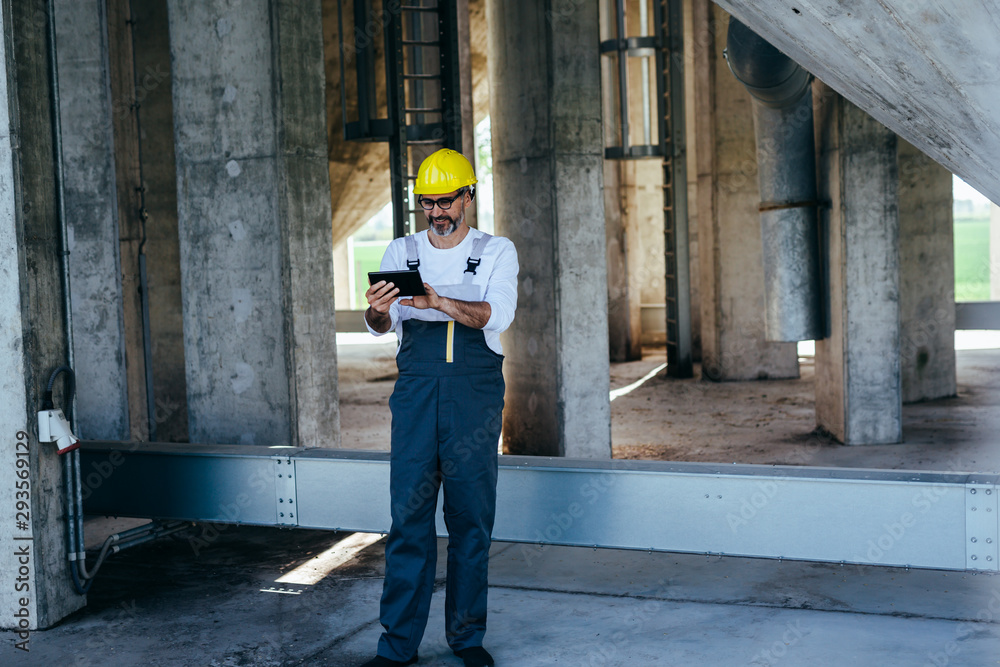 worker using tablet on construction site worker using tablet on construction site