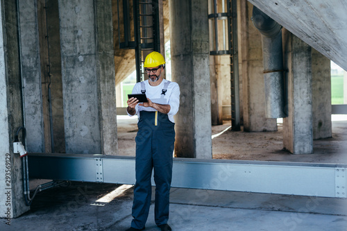 worker using tablet on construction site