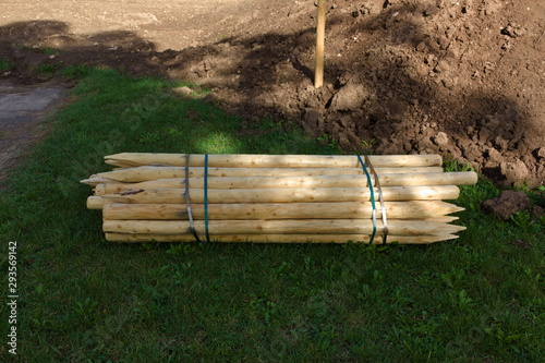 Obraz na plátně Wooden stakes held together with metal bands