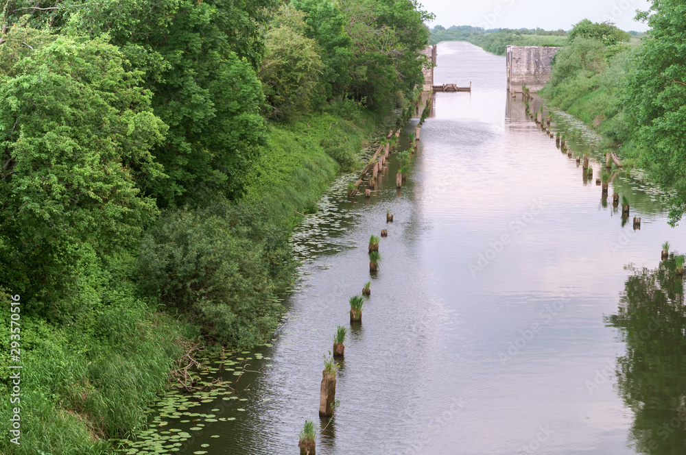 Abandoned old canal and destroyed bridge. Artificial pond canal.