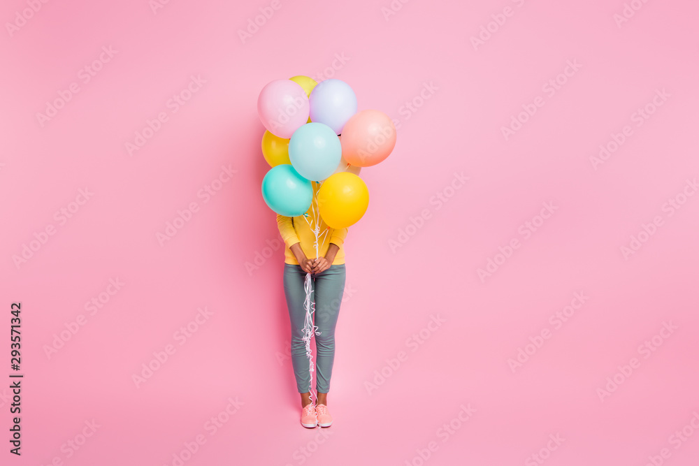 Hide-and-seek concept. Full body photo of pretty cute nice happy ten girl having party on birthday hiding behind many ballons hold in hands isolated pastel multicolored background Hide-and-seek concept. Full body photo of pretty cute nice happy ten girl having party on birthday hiding behind many ballons hold in hands isolated pastel multicolored background