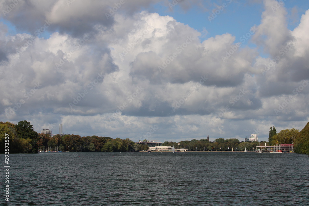 Overview of the lake and cityscape under a cloudy sky