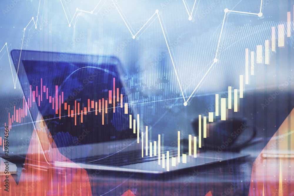 Stock market chart hologram drawn on personal computer background. Double exposure. Concept of investment. Stock market chart hologram drawn on personal computer background. Double exposure. Concept of investment.