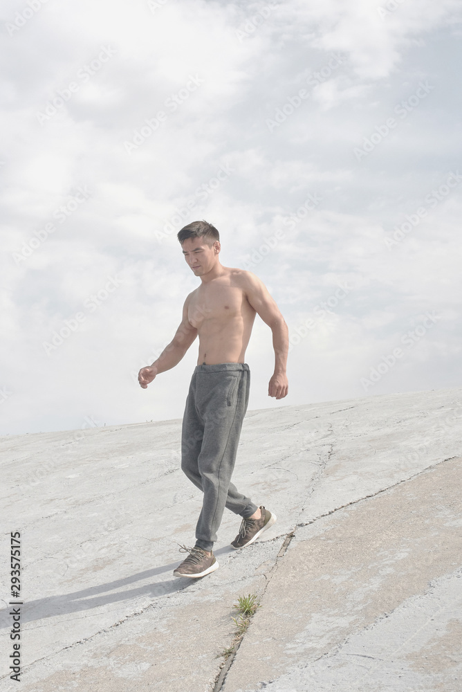 Asian athlete training outdoors in the morning, photo of Kazakh wrestler's workout in style of minimalism