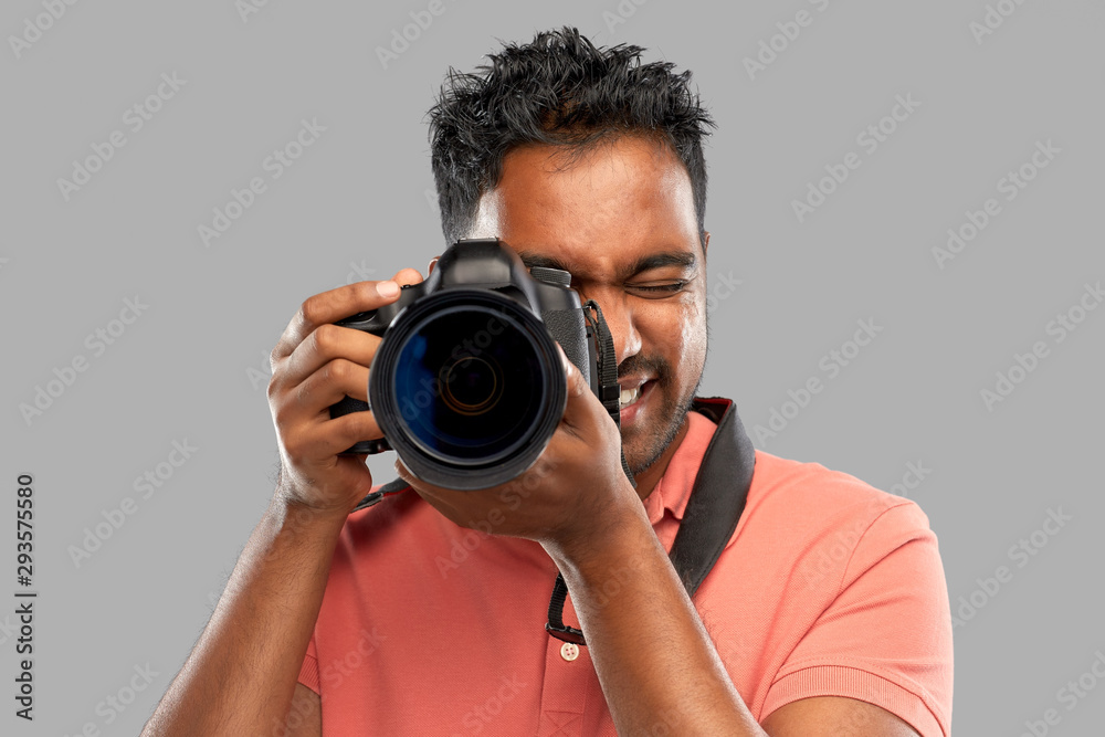photography, profession and people and concept - happy indian man or photographer with digital camera over grey background photography, profession and people and concept - happy indian man or photographer with digital camera over grey background