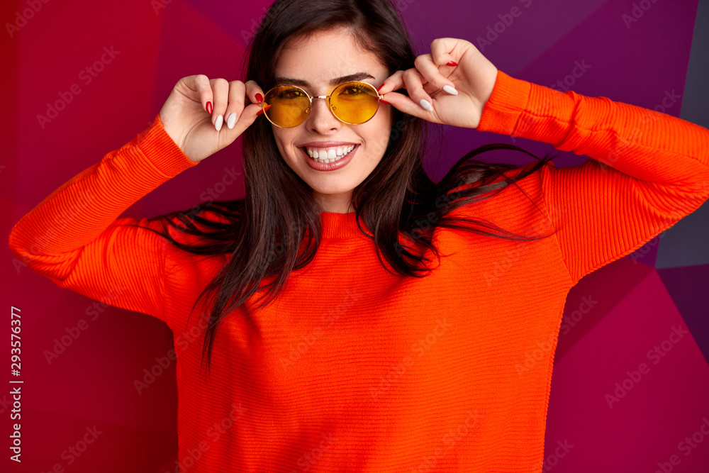 Stylish female in yellow glasses and red outfit Stock Photo | Adobe Stock