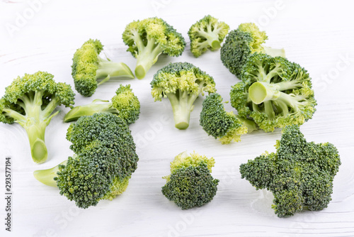 group of several broccoli on white wooden surface