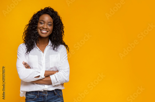 Confident smiling african american girl with crossed hands on chest photo