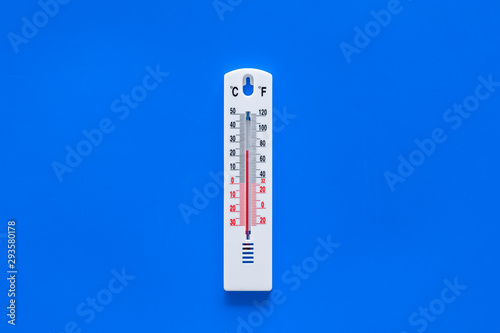 Weather thermometer on blue background top view copy space