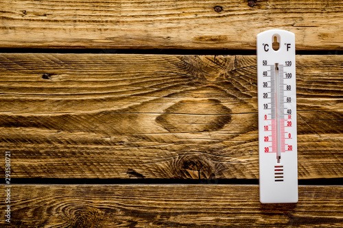 Weather thermometer on dark wooden background top view copy space