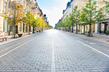 City street with empty road and morning light in Europe, Lithuania, Vilnius