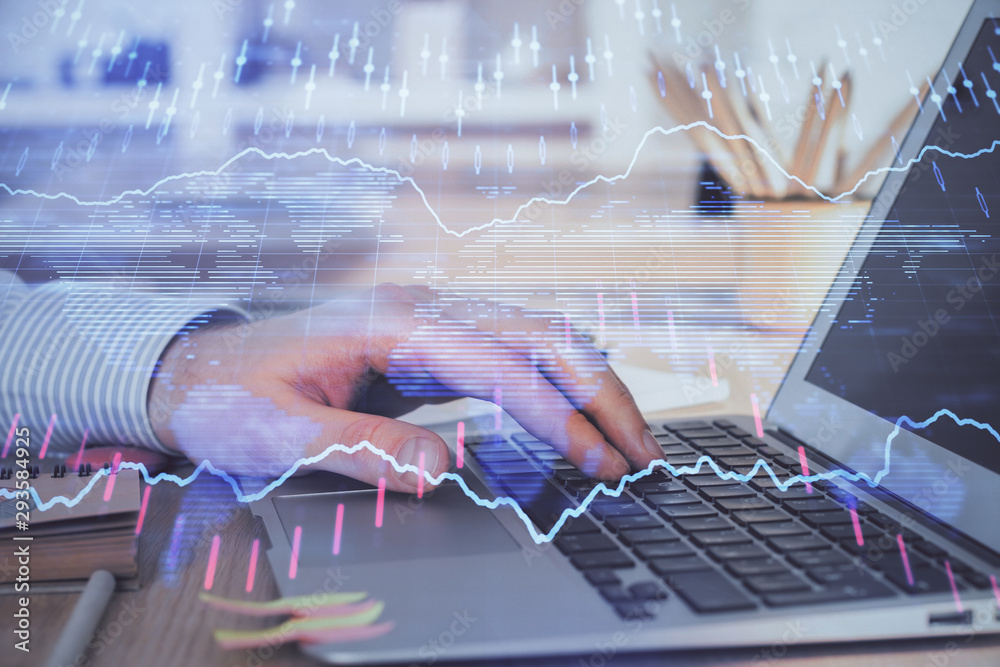 Double exposure of man's hands writing notes with laptop of stock market with forex graph background. Concept of research and trading. Double exposure of man's hands writing notes with laptop of stock market with forex graph background. Concept of research and trading.