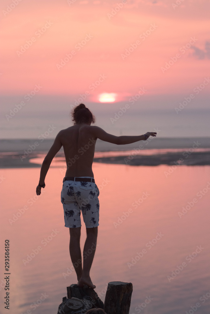 Fototapeta premium silhouette of a man running on the beach at sunset (Dune Du Pyla, France)