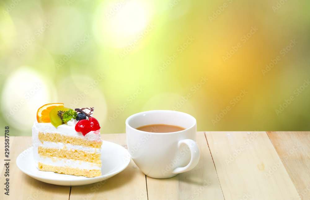 Slice cake with coffee cup on wood , green blur background