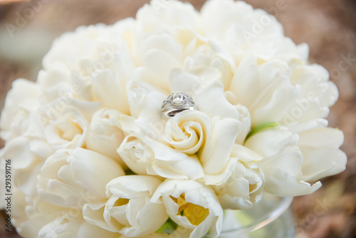 White Wedding Bouquet of White Flowers with Wedding Ring on It