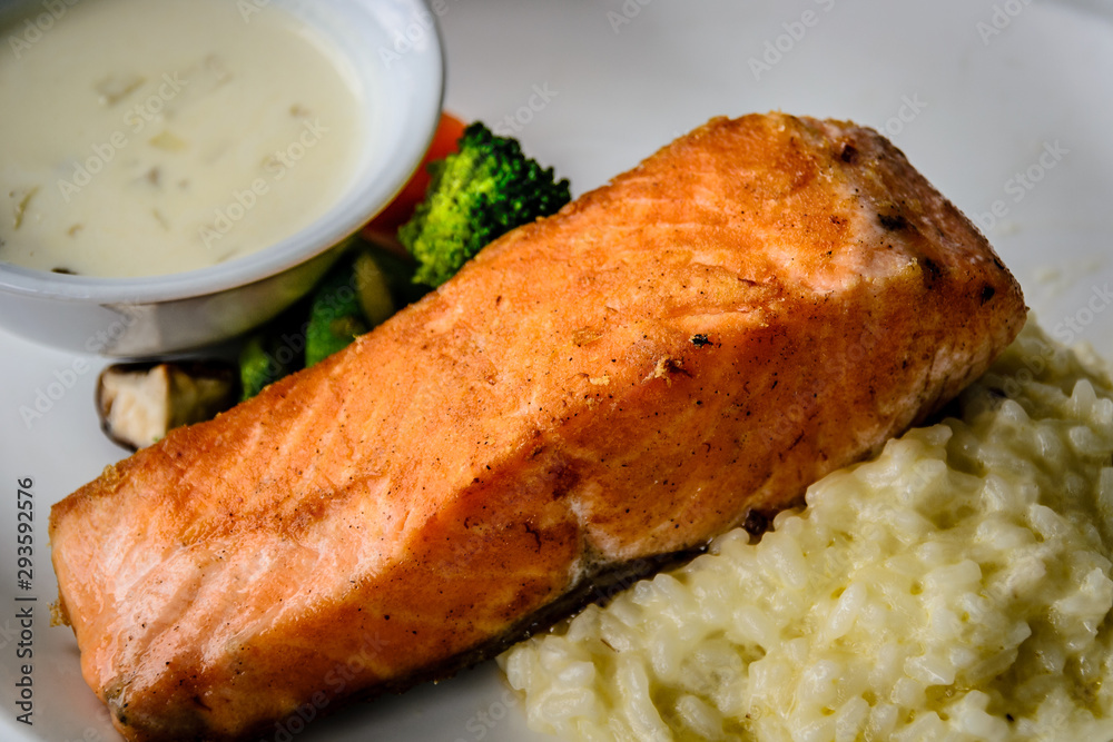 pan fried salmon chunk served with creamy rice risotto and boiled vegetables pan fried salmon chunk served with creamy rice risotto and boiled vegetables