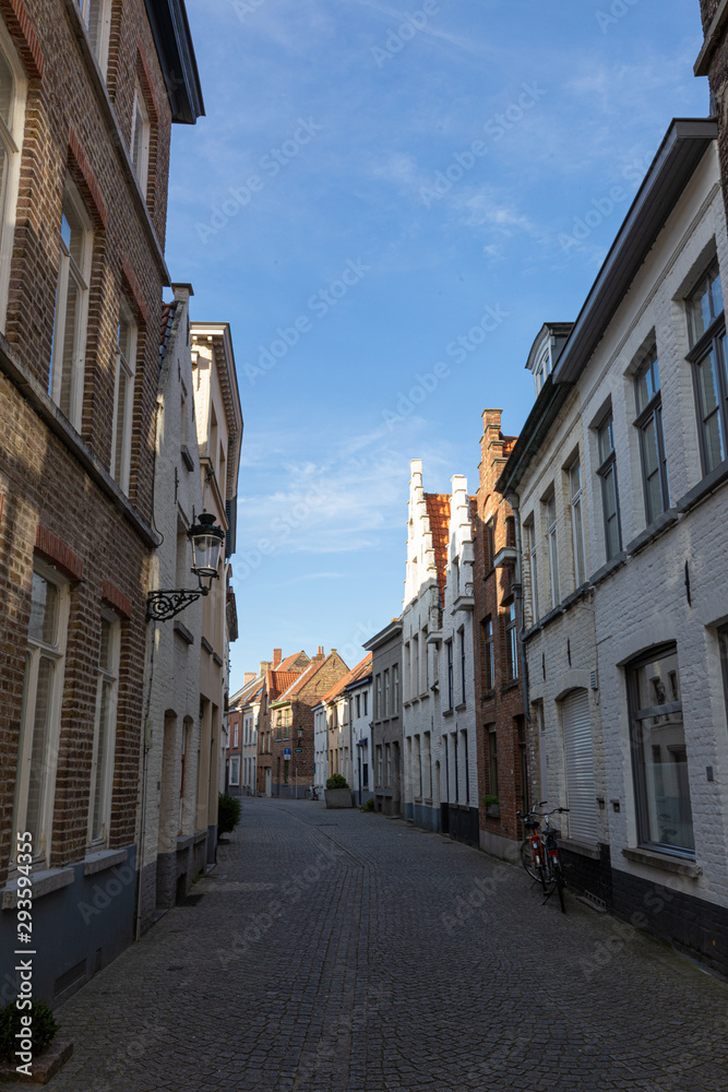 Narrow street between houses old town Brugge, Belgium