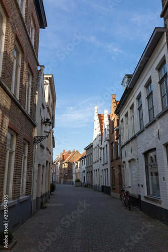 Narrow street between houses old town Brugge, Belgium © A_Skorobogatova