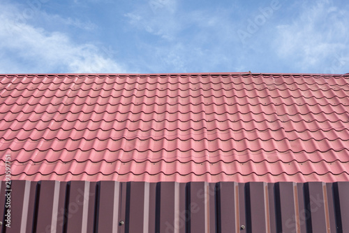 Roofing roof. Roof covering of a country house. The tile is laid in even rows.