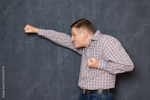 Funny awkward man is posing like brave flying superman