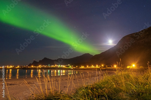 Aurora borealis over the beach and the village of Ramberg on the Lofoten Islands in Norway in Autumn photo