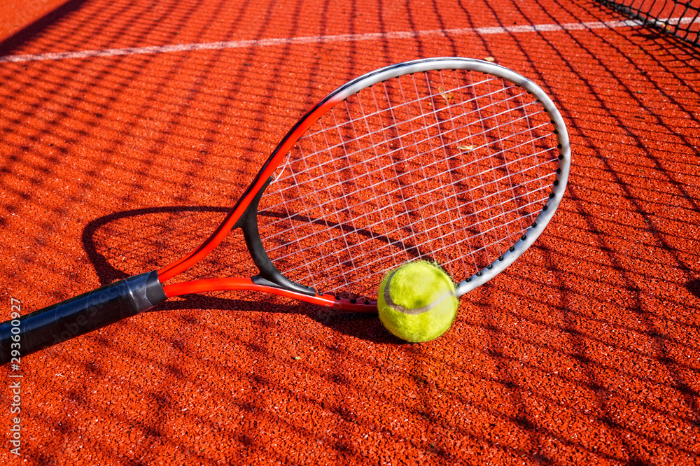 Tennis ball and racket on an outdoor court
