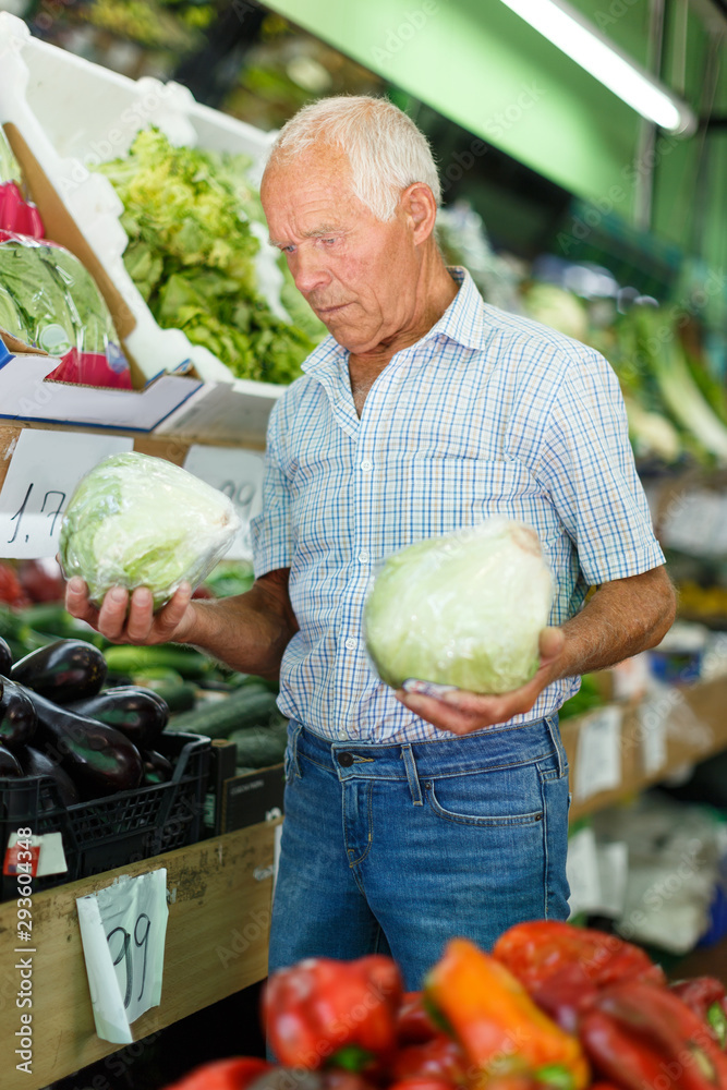 Fototapeta premium Man choosing vegetables in store