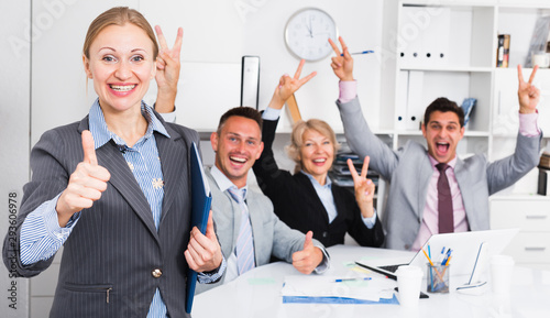 Happy business group with woman at office photo