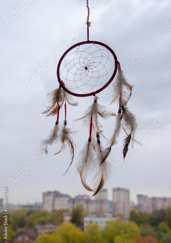 A Dreamcatcher suspended from a window. magic talisman.