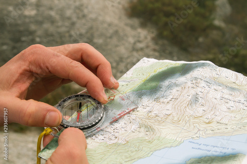 Quadro su tela Orienteering with topographic map and compass