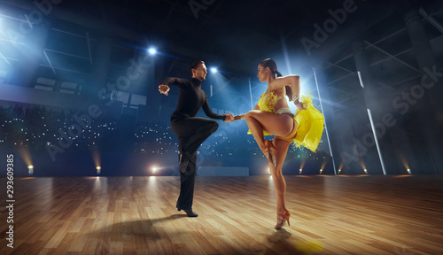 Fotografie, Obraz Couple dancers  perform latin dance on large professional stage