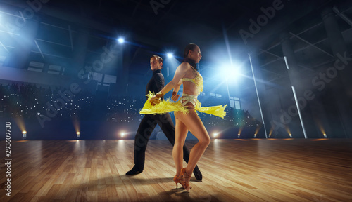 Couple dancers  perform latin dance on large professional stage. Ballroom dancing. photo