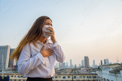 Asian woman officer wearing masks protect toxic dust in the air are polluting the capital of Bangkok.Thailand Bangkok Having to air PM25 (fine particulate matter) pollution crisis. photo