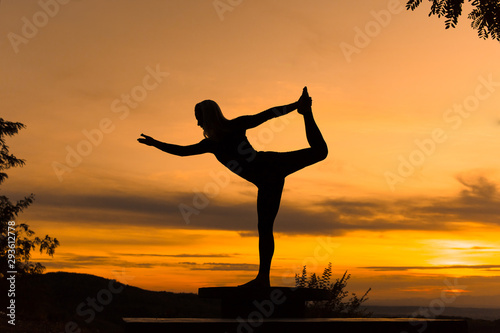 Silhouette woman coach yoga practice at sunset. Yoga concept. Dancer