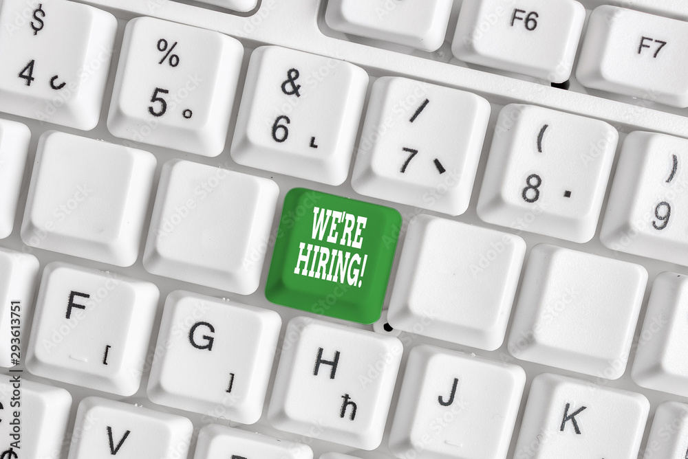 Handwriting text writing We Re Hiring. Conceptual photo recently employ someone or pay someone to do particular job White pc keyboard with empty note paper above white background key copy space Handwriting text writing We Re Hiring. Conceptual photo recently employ someone or pay someone to do particular job White pc keyboard with empty note paper above white background key copy space
