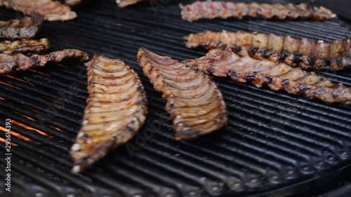 Pork ribs grill roasted on a rotating grill. Fried pork barbecue. Street food, festival. photo