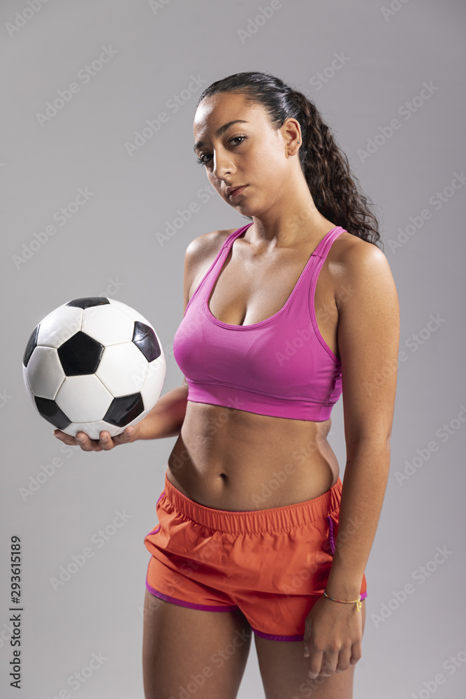 Young woman in sportswear holding ball Young woman in sportswear holding ball