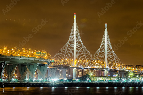 St. Petersburg Neva river morning day evening night sunset dawn during winter summer spring autumn cable-stayed bridge Zenit Arena Lakhta center reflection in water, glows and lights photo