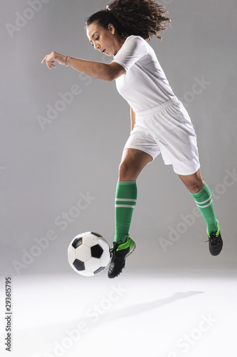Fit young woman playing football