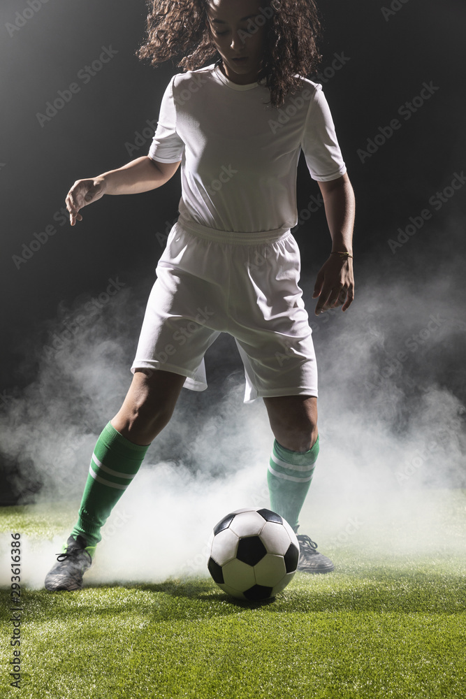 Adult fit woman playing football