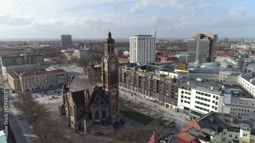 Aerial view of church in Malmö city in Southern Sweden. Drone shot flying over street and buildings, church in Triangeln district photo