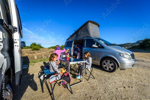 Fototapeta Motorhome RV or campervan is parked on a beach.