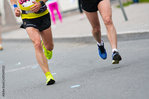 Marathon race. Closeup of the feet of runners. Muscle work © watman