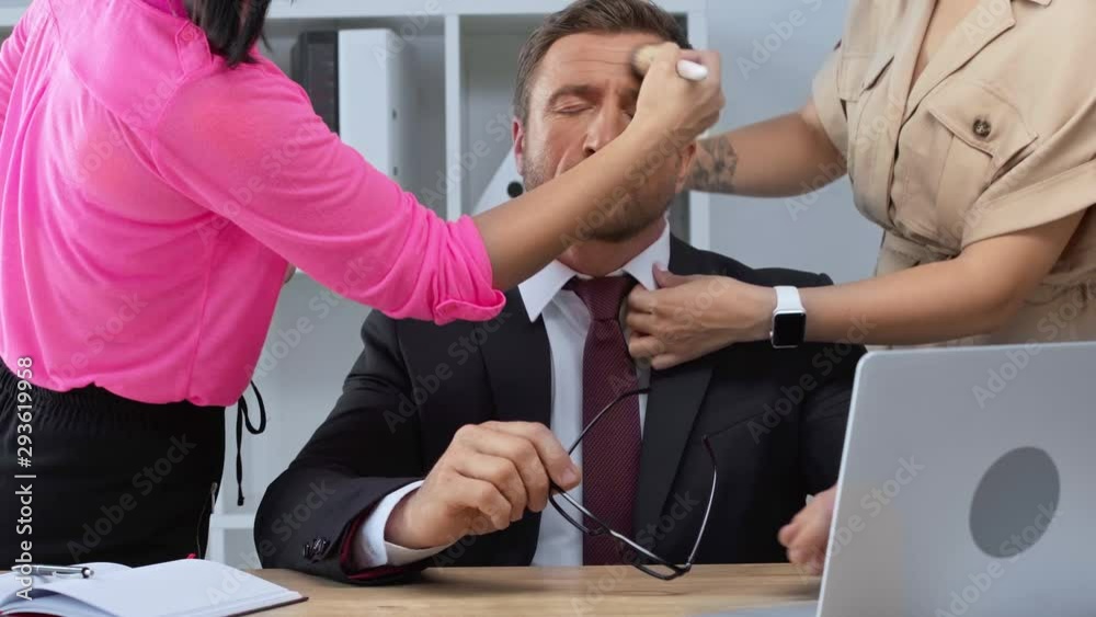 stylist and makeup artist preparing mature businessman in office stylist and makeup artist preparing mature businessman in office