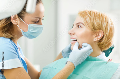 Dentist checks the teeth of a girl