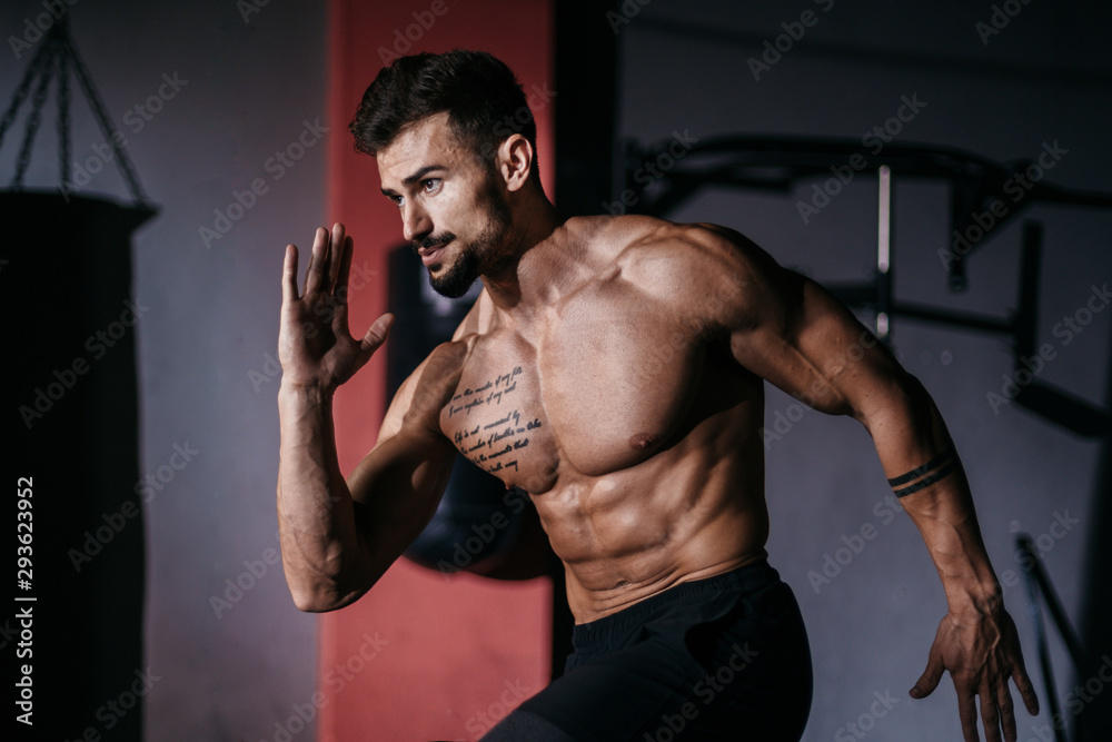 Attractive fit body guy take the ruby poses then start to run in a cross fitness class he doing a intense workout training