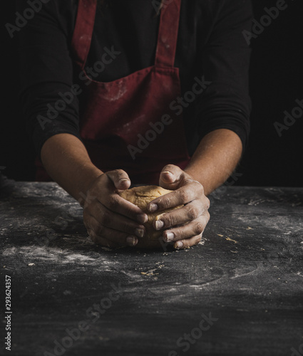 Front view baker kneading dough
