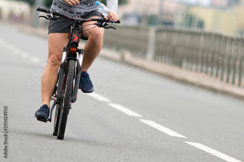 Cyclist on a city road. Close-up